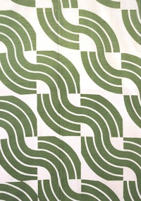 a green and white fabric with wavy lines on it
